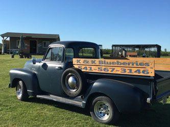 a blue truck that says K and K Blueberries on the side
