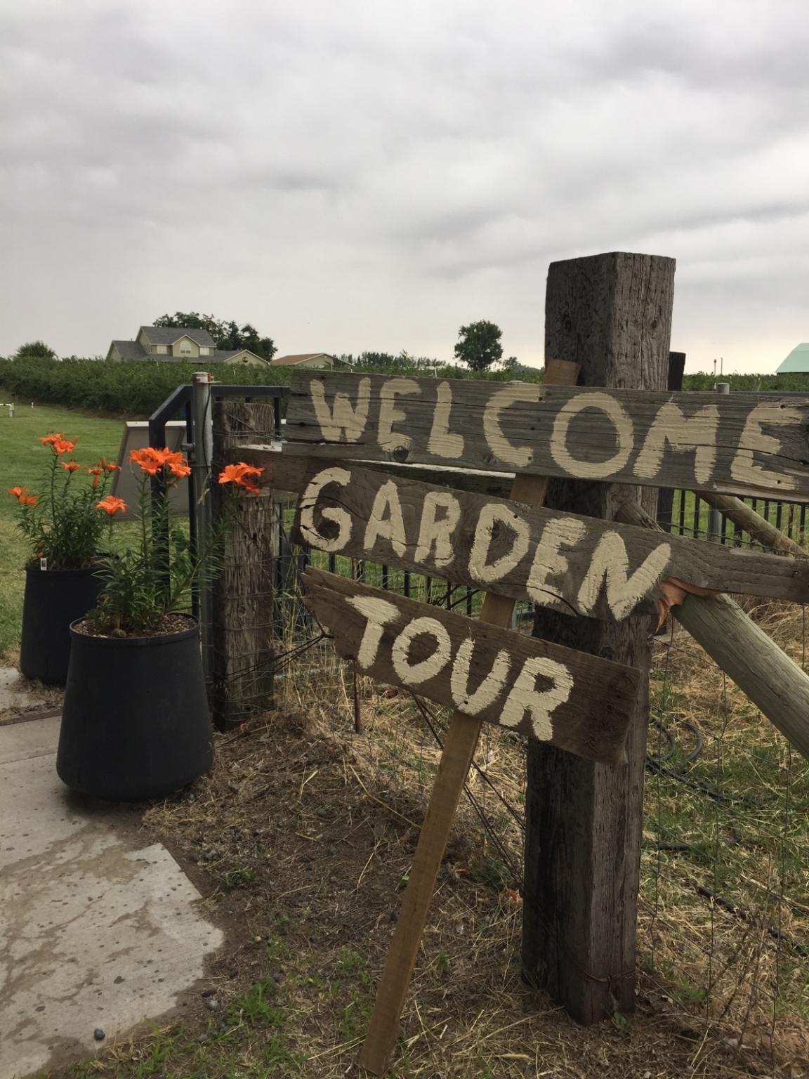 a sign says welcome garden tour