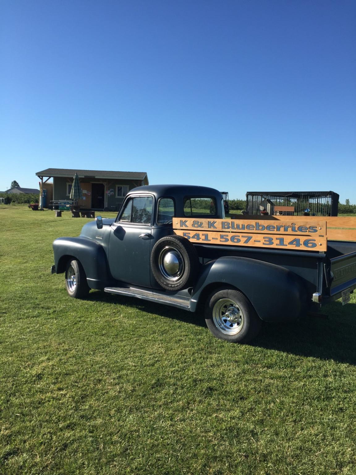 an old chevy pickup with clear blue skies