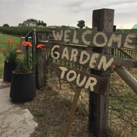a sign says welcome garden tour
