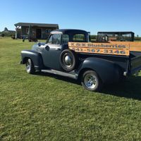 an old chevy pickup with clear blue skies
